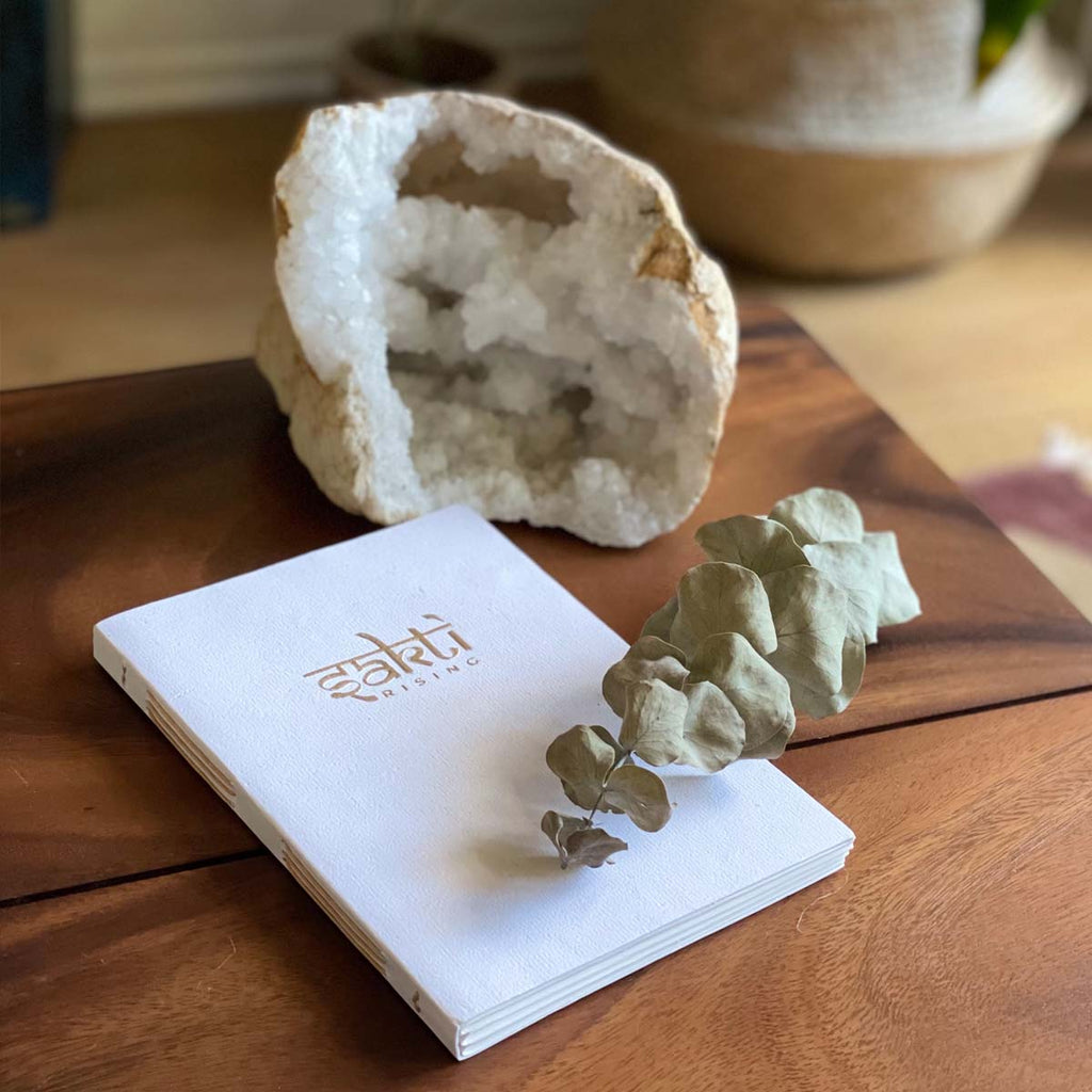 Sakti Rising journal handmade with recycled paper. Sustainably and ethically sourced, shown with a calming crystal.