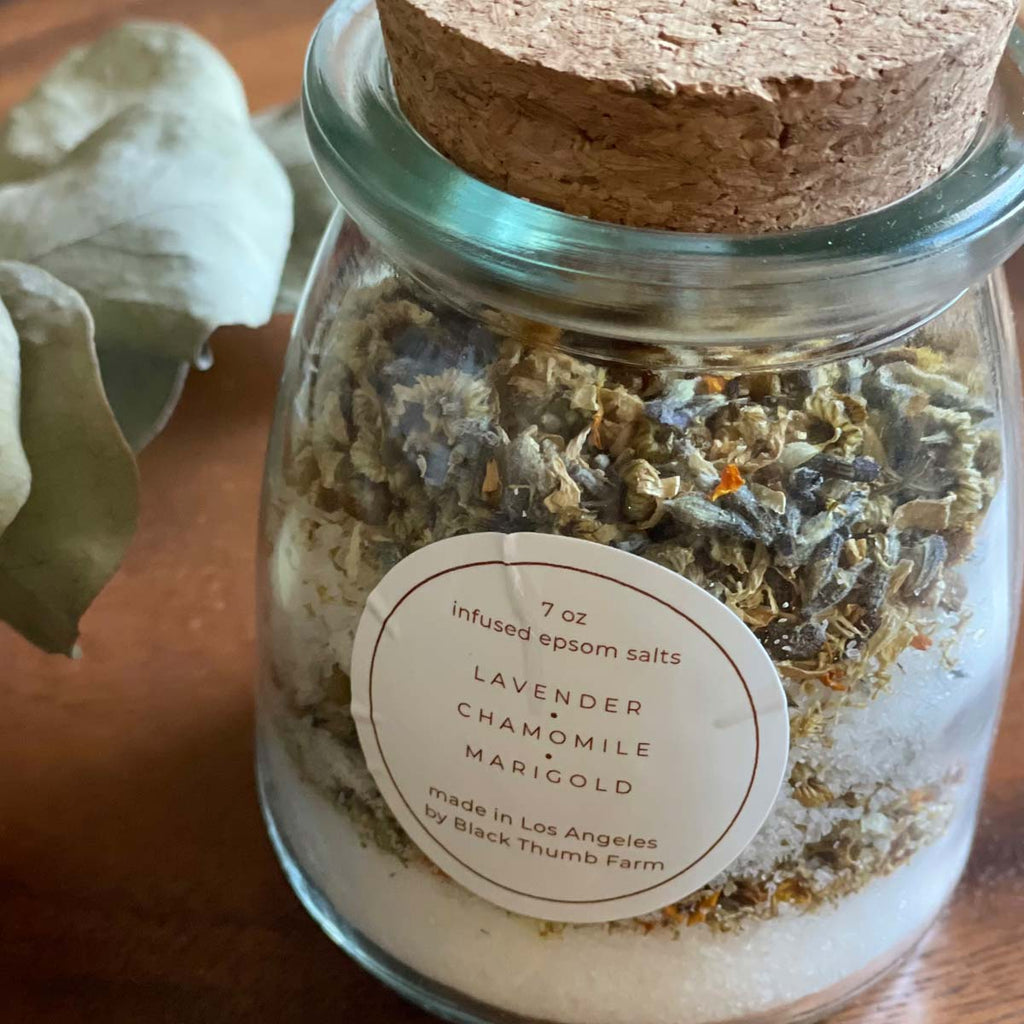Sakti Rising and Black Thumb Farm herbal bath salts. Sustainably and ethically sourced. Small glass jar with cork lid, containing herbal bath salt blend of Lavender, Chamomile, and Marigold. Made in Los Angeles