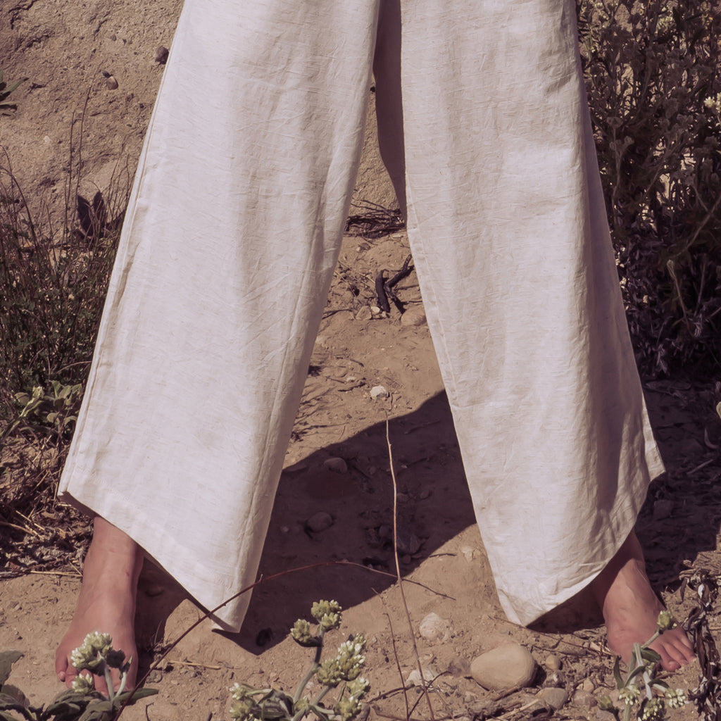 Image of woman's legs in wide-leg stance, wearing Sakti Rising Durga Pants. Ecofriendly sustainable yoga apparel that gives back to marginalized communities around the world.