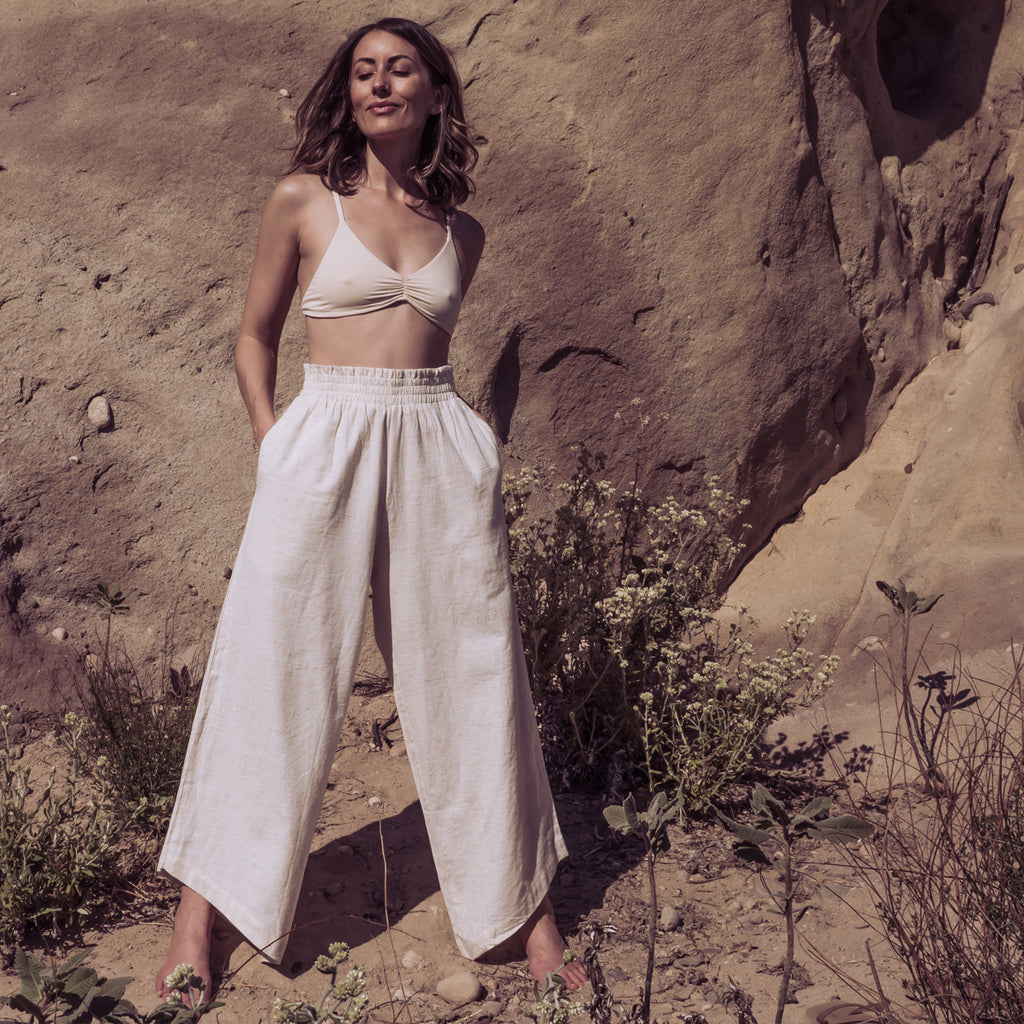 Image of a woman wearing Sakti Rising Durga Pants and Devi Bralette. Ecofriendly sustainable yoga apparel that gives back to marginalized communities around the world.