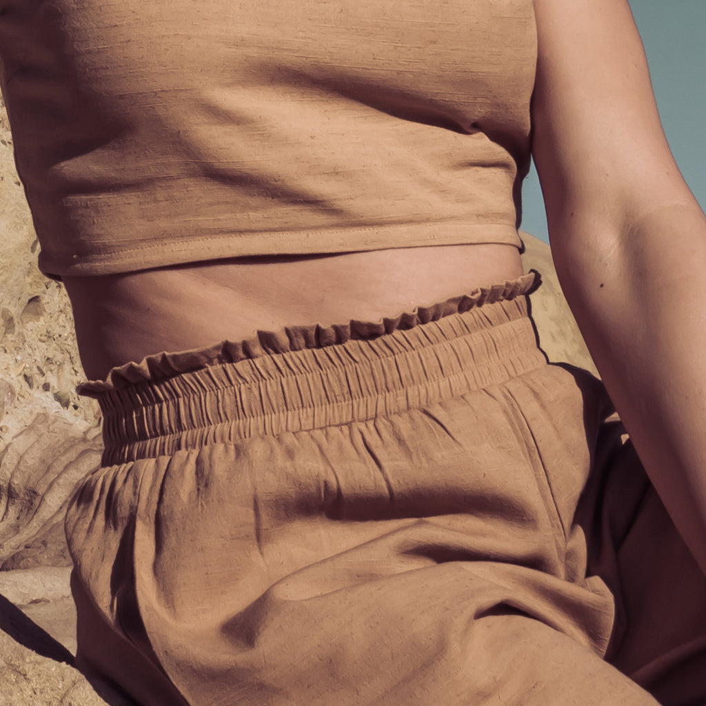 Detail of ruched waistline of Sakti Rising Durga Pants. Ecofriendly sustainable yoga apparel that gives back to marginalized communities around the world.