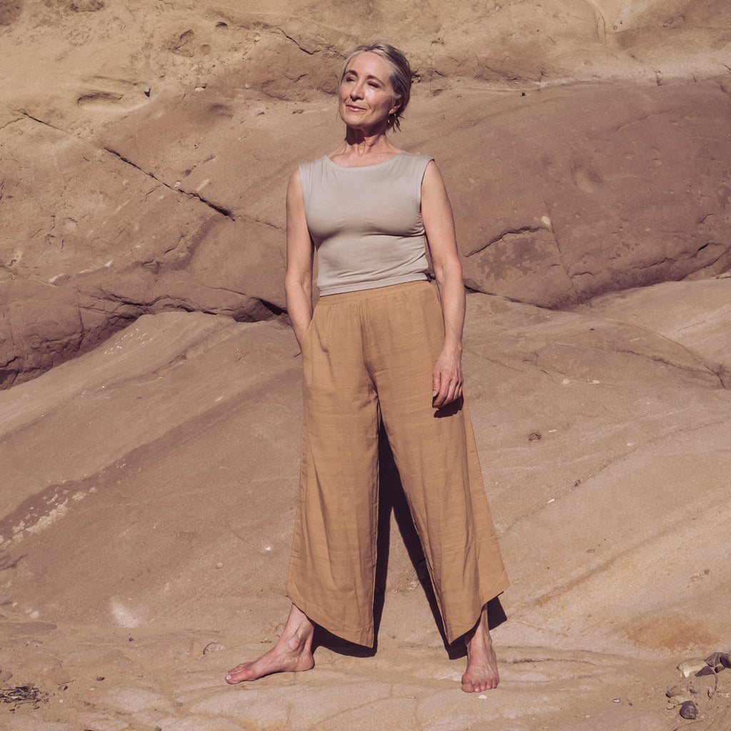 Woman standing in wide-leg stance wearing Sakti Rising Durga Pants and Tara Tank. Ecofriendly sustainable yoga apparel that gives back to marginalized communities around the world.